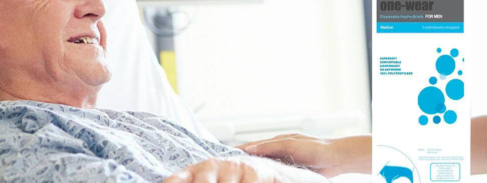 Man wearing disposable briefs sitting in a hospital bed